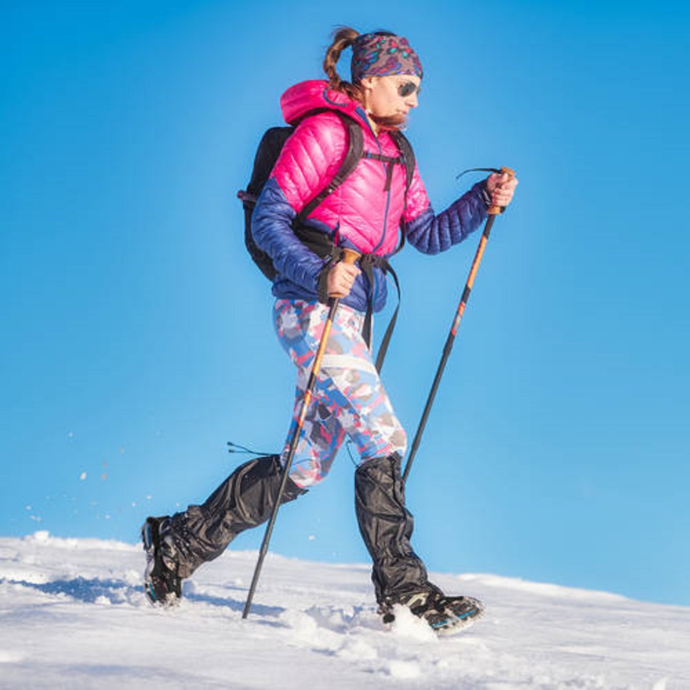 Snow hike with light crampons. A young woman